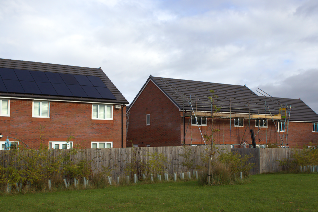 Homes in Culcheth, one with solar, one with solar being installed.